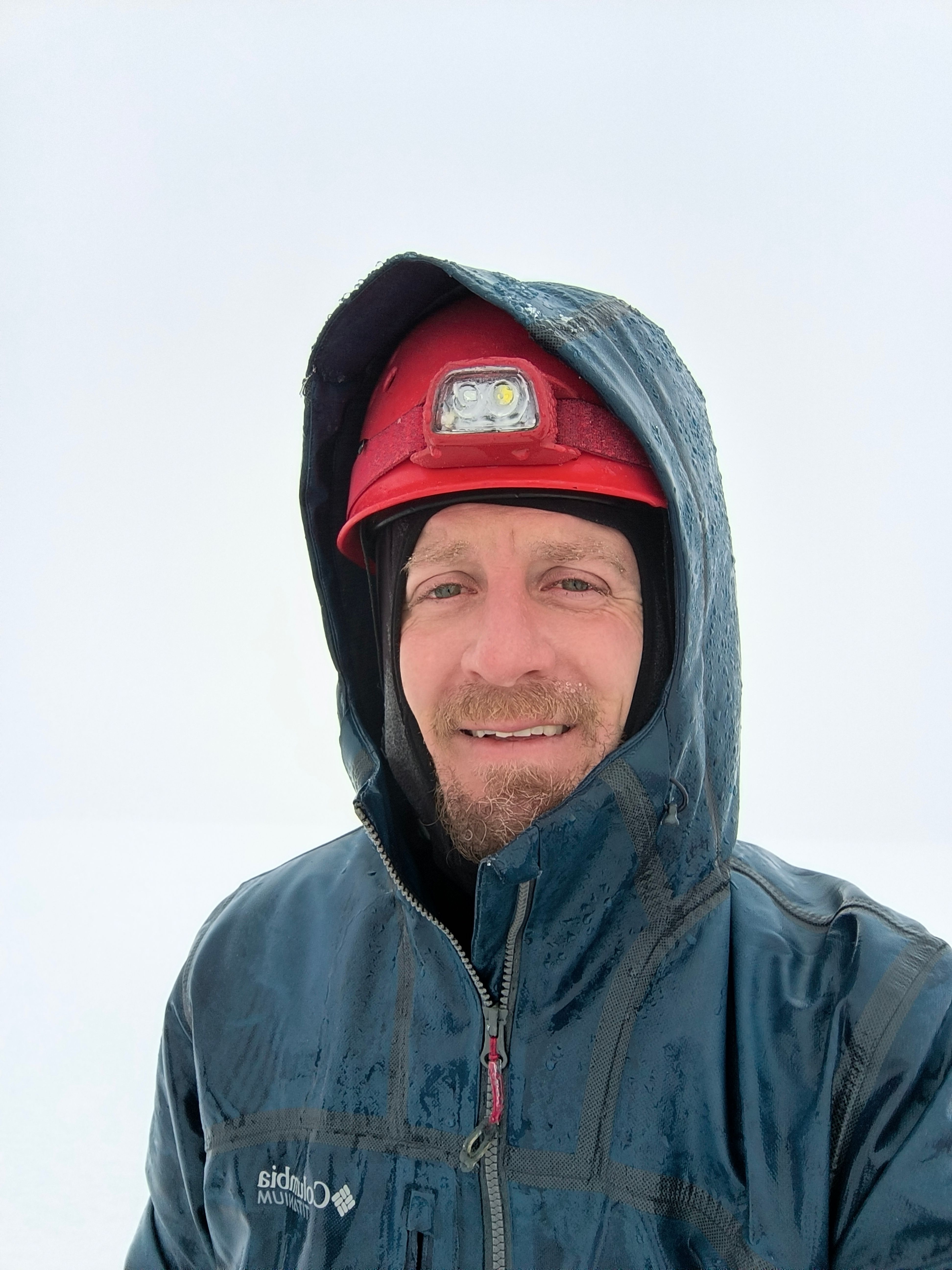 A quick selfie at the summit in the whiteout.