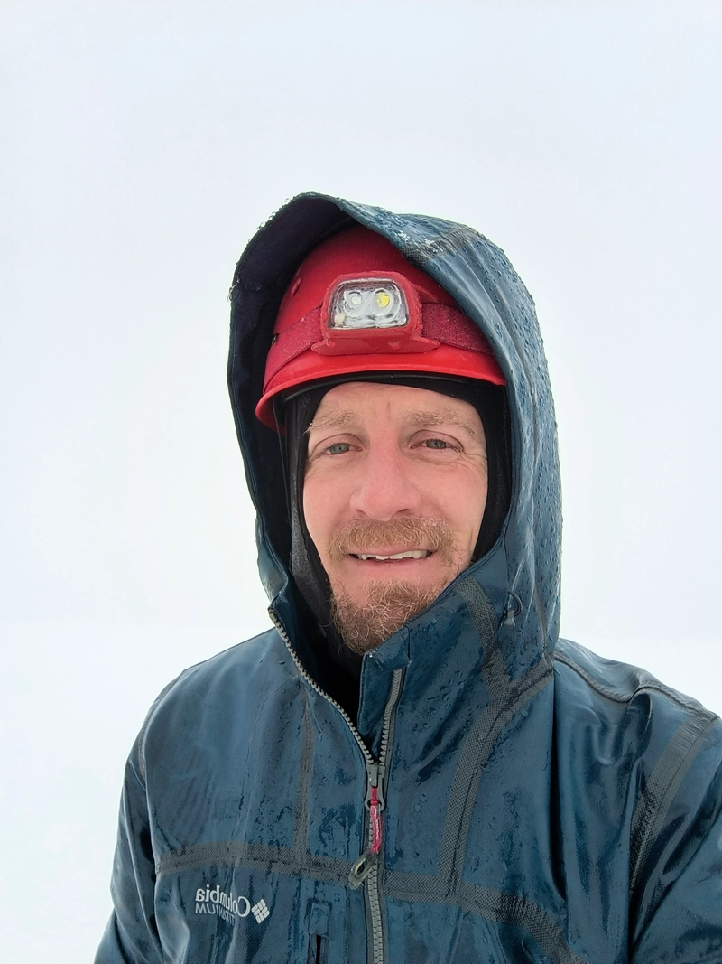 A quick selfie at the summit in the whiteout.